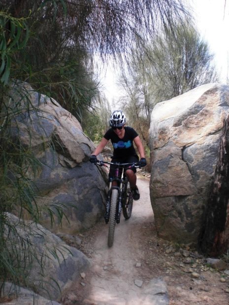 Jess riding between rocks at Mount Stromlo